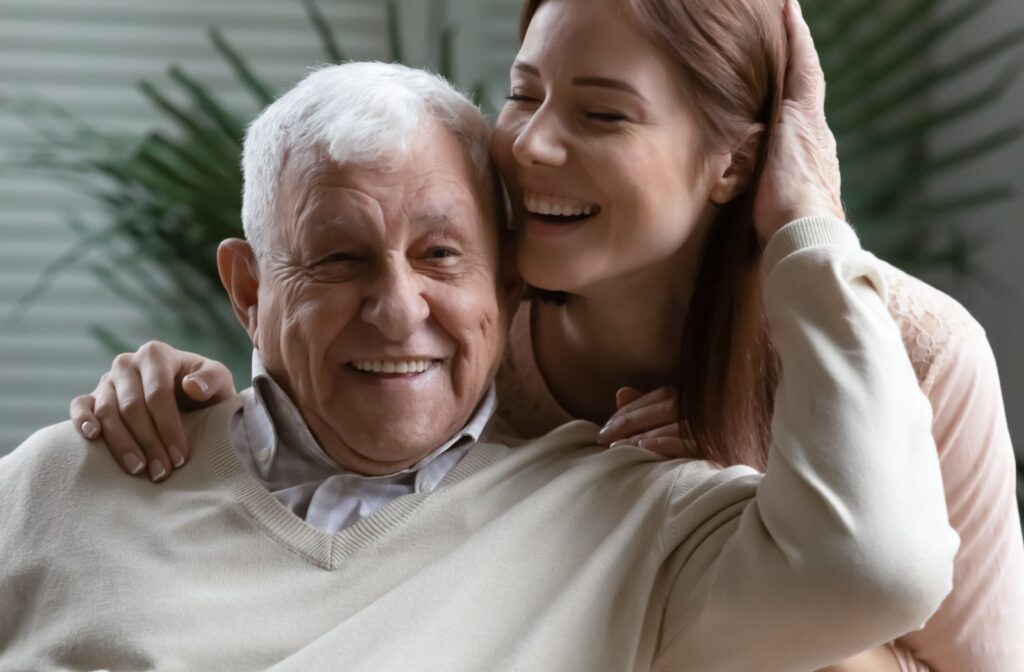 Senior man and daughter smiling.