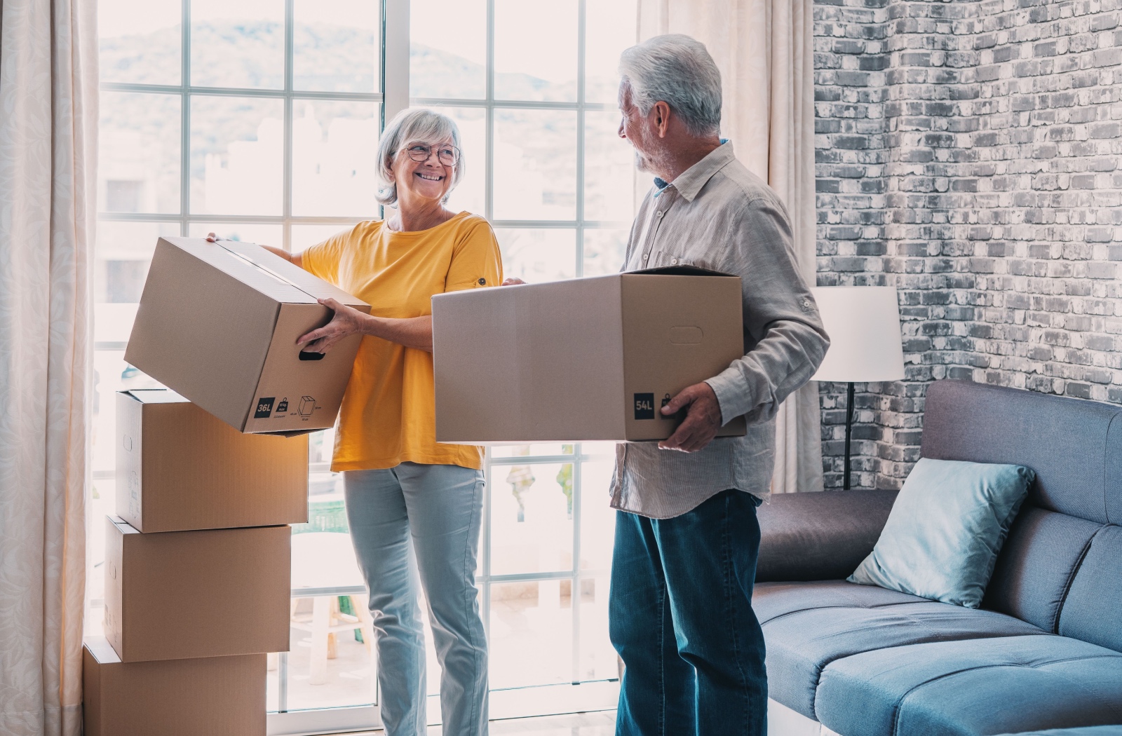 A senior couple moving into their new assisted living community home.