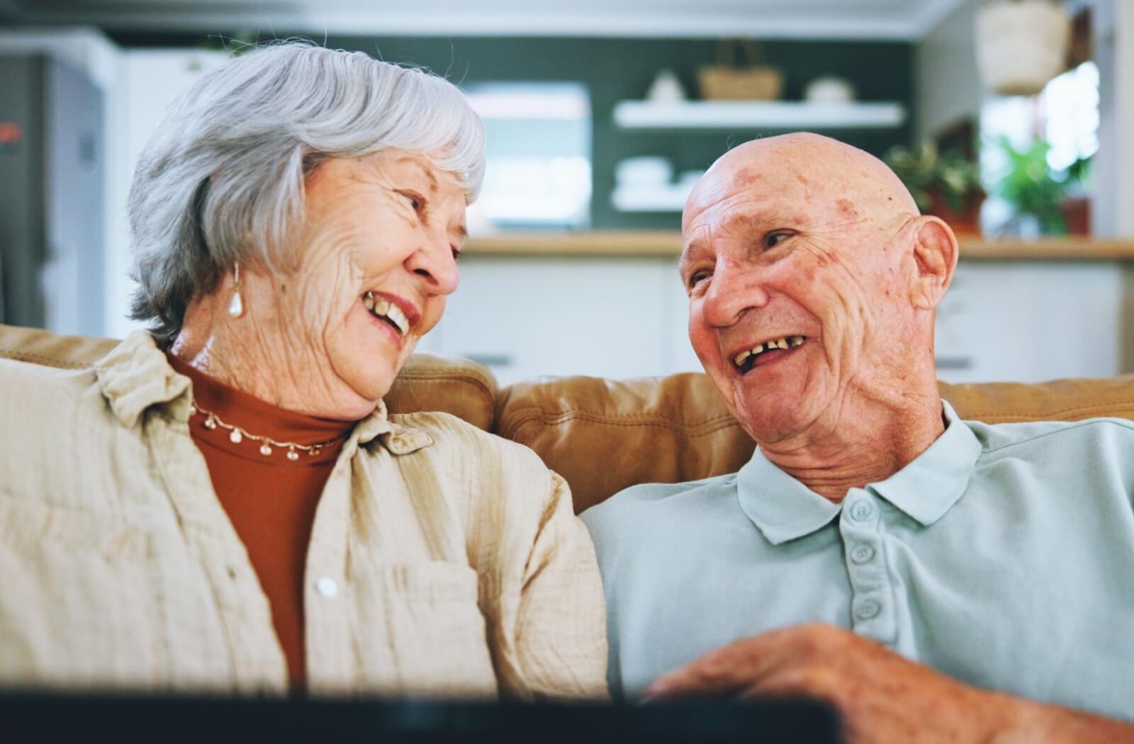A happy memory care nurse greets a senior resident for the first time.
