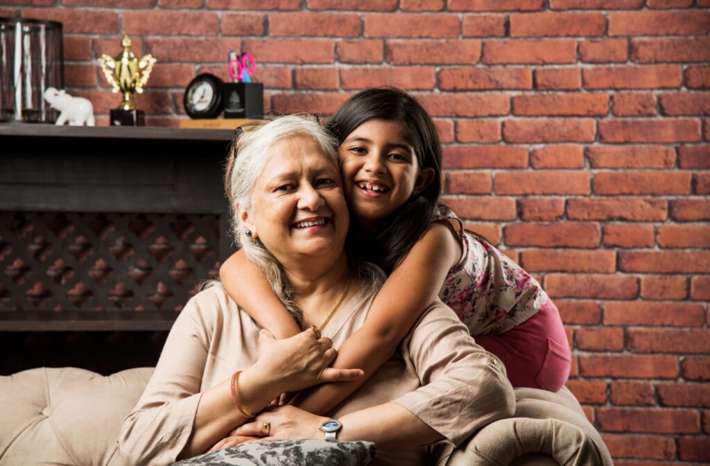 A Senior shares an embrace with their grandchild who is an extension of their support system.