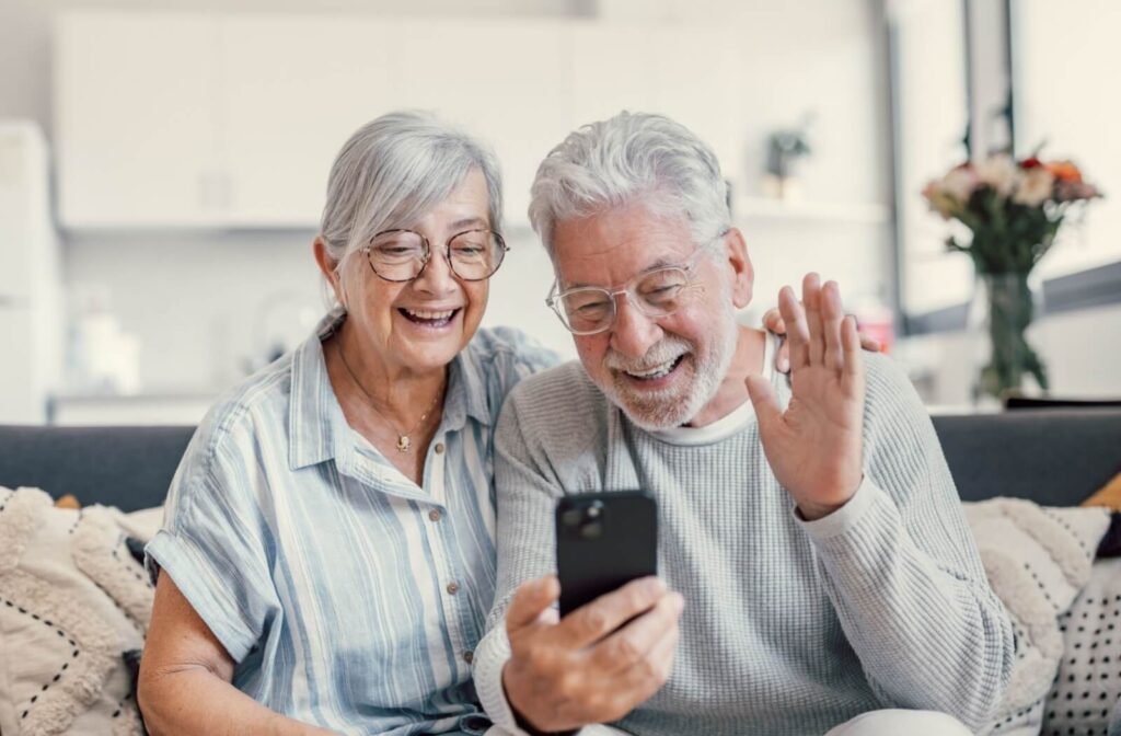 A senior couple talks over video call with their family to keep in touch.