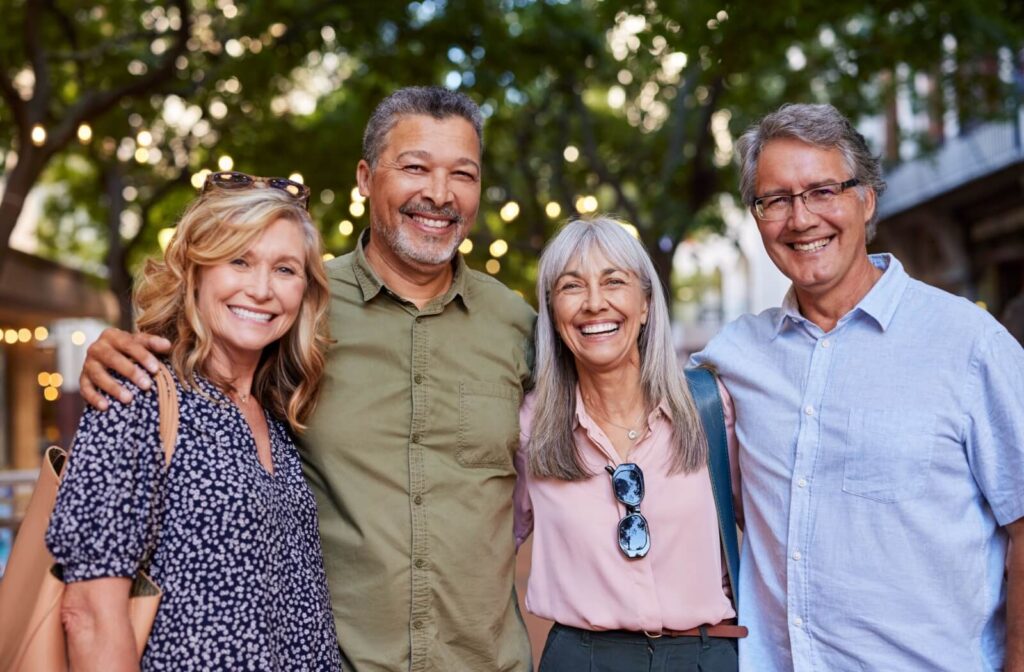 Group of older adults socializing outdoors during a community outing in retirement living